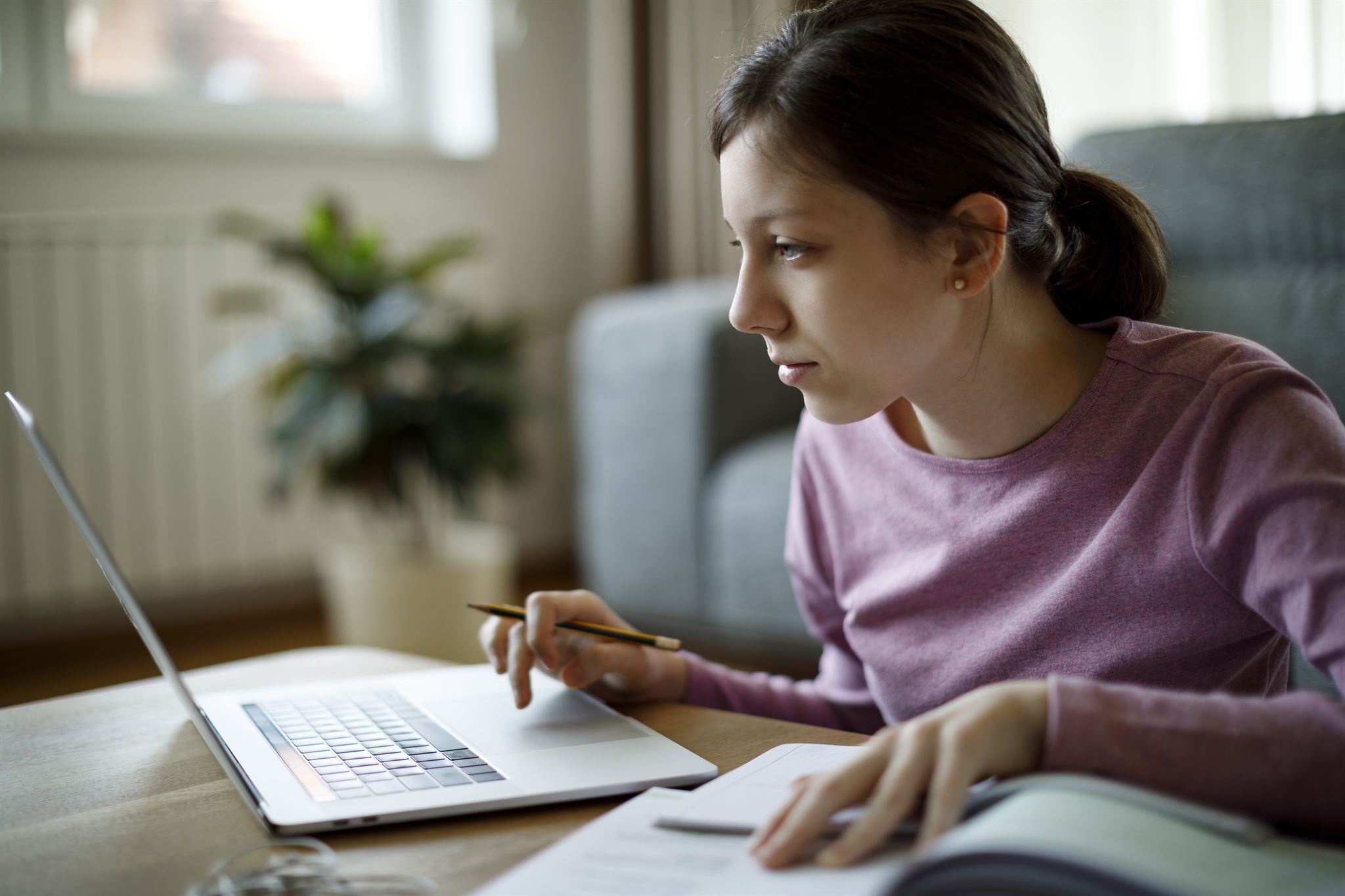 Teen-girl-studying-with-laptop